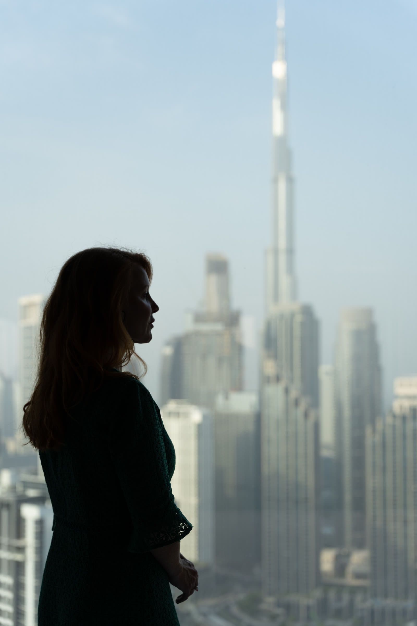 A woman looking out over the Dubai skyline
